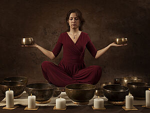 Woman with Tibetan bowls in her hands