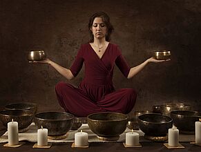 Woman with Tibetan bowls in her hands