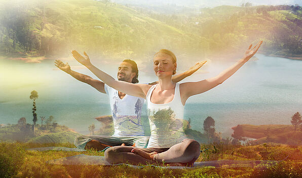 smiling couple making yoga exercises outdoors